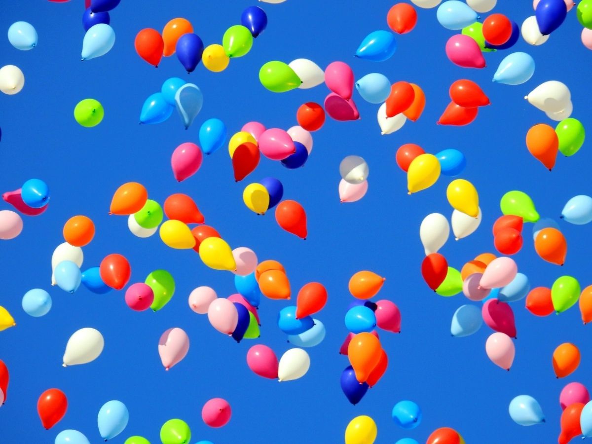 Coloured balloons in sky