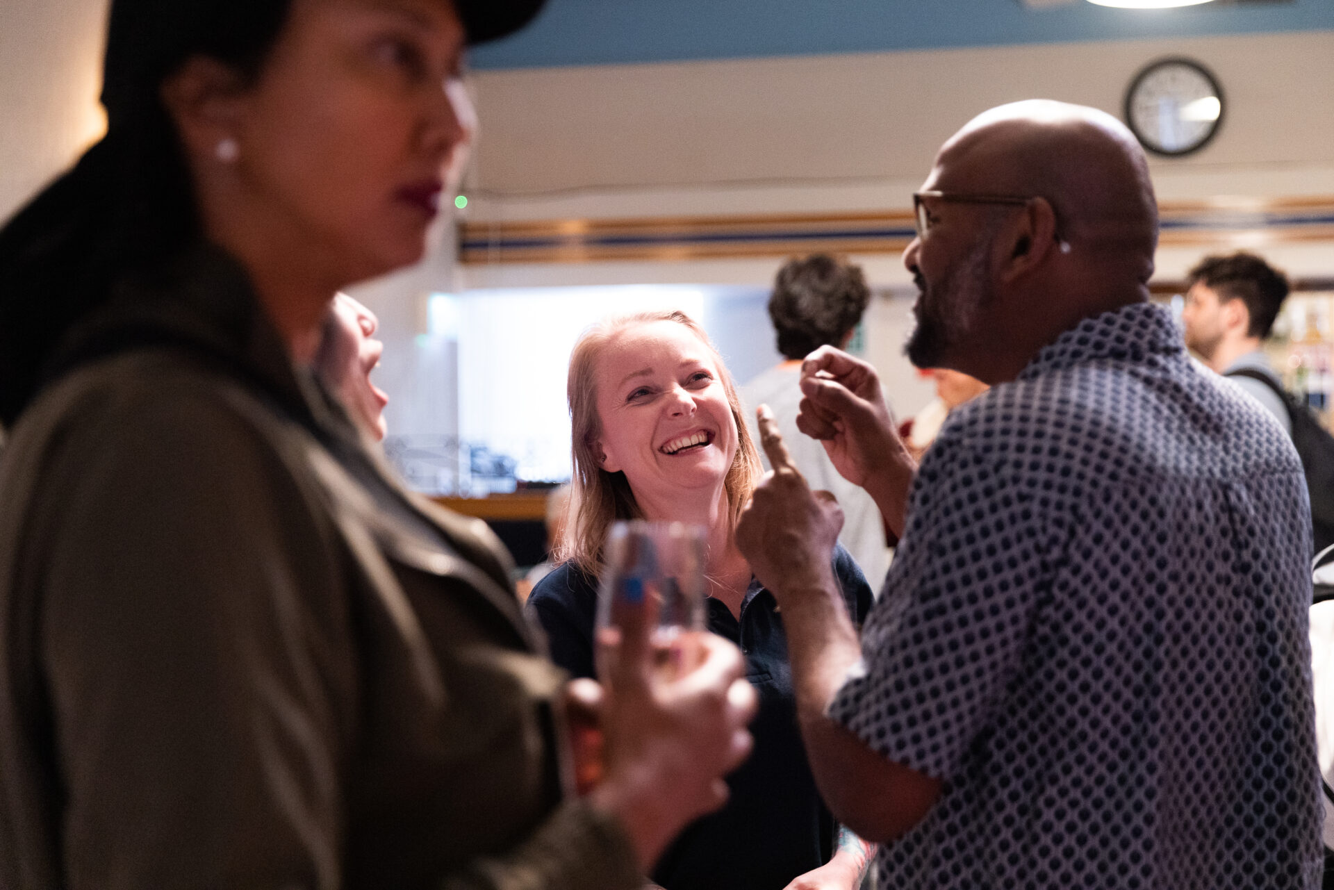 People smiling and signing in a bar.
