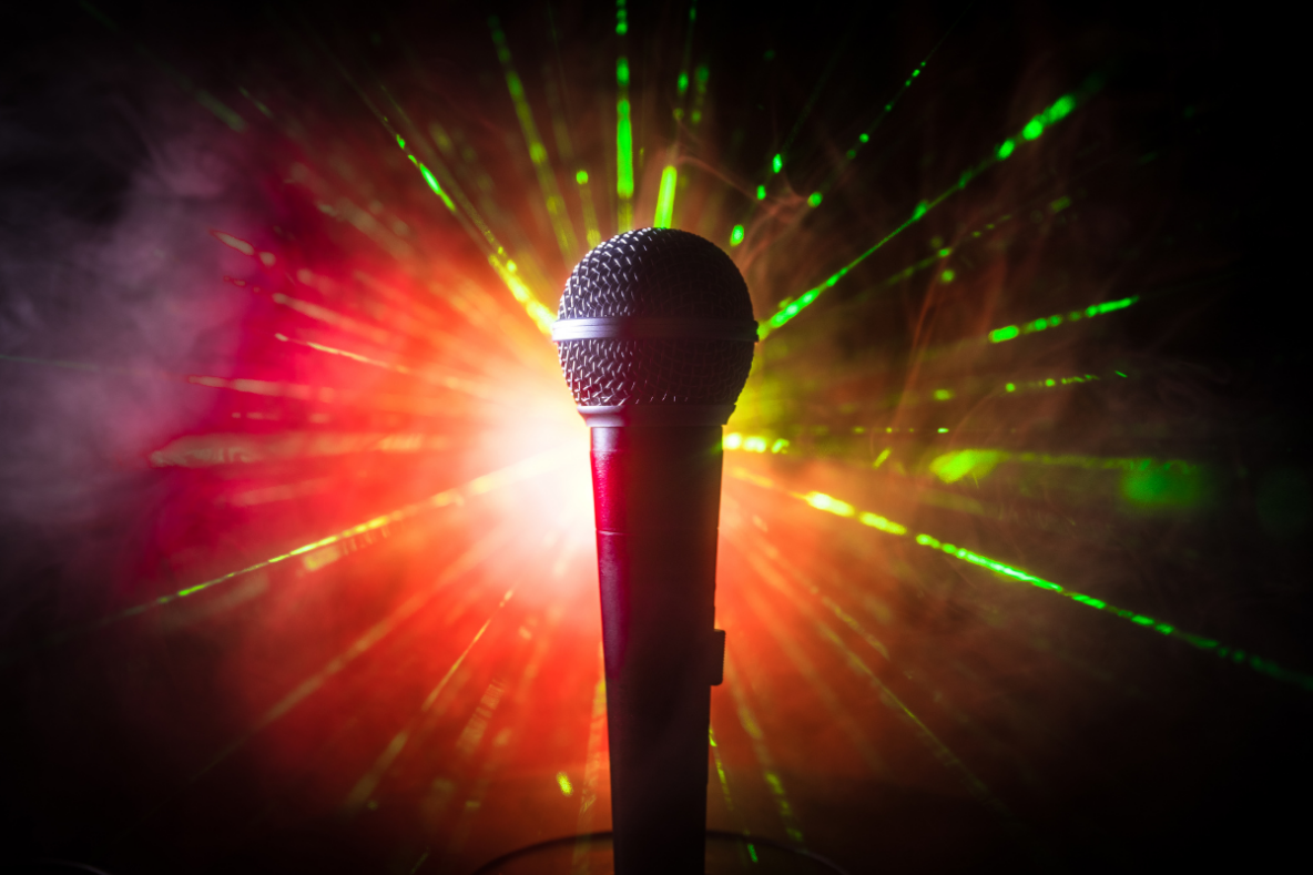 a microphone with bright green and red lights shining behind it