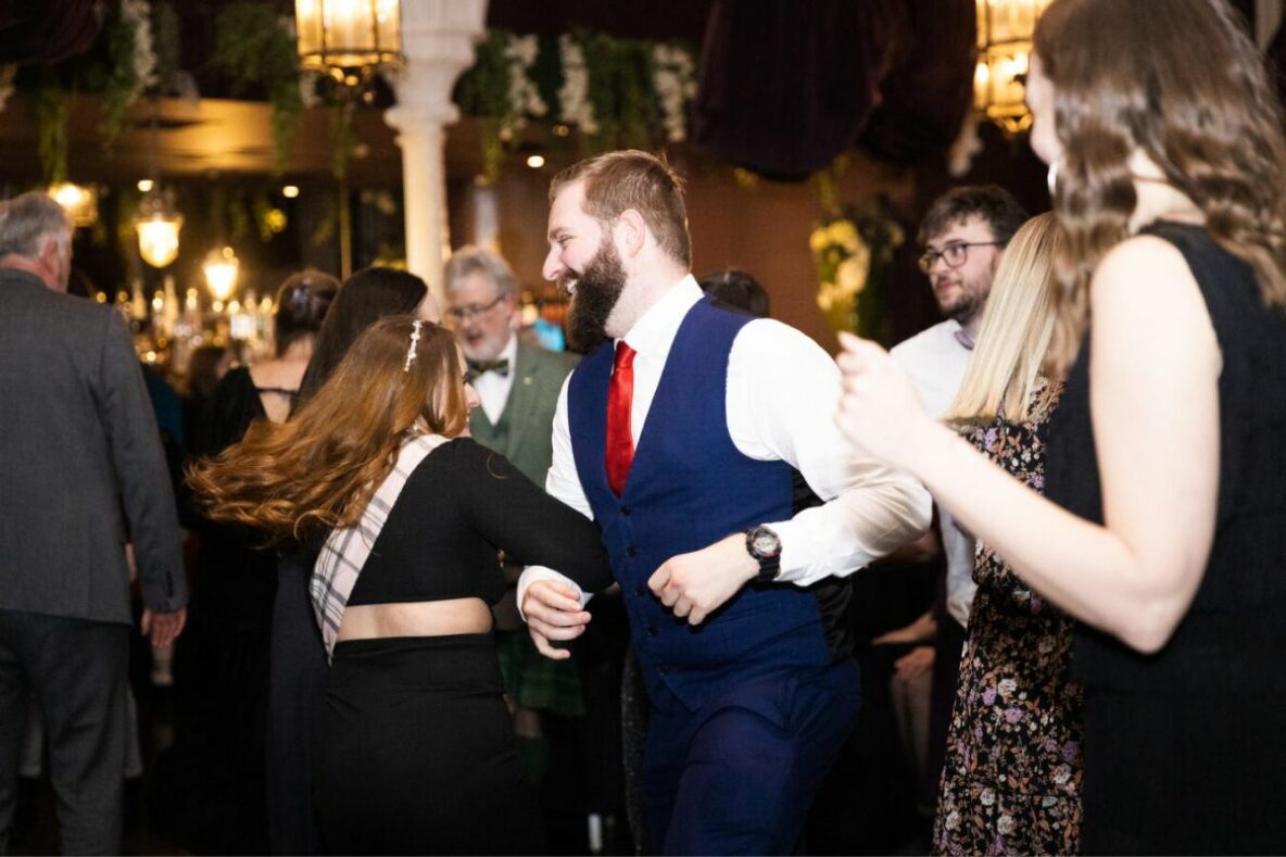 A man and woman dancing at a Scottish ceilidh.