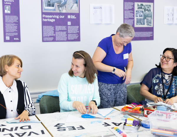 Four people engaging with each other at a craft club